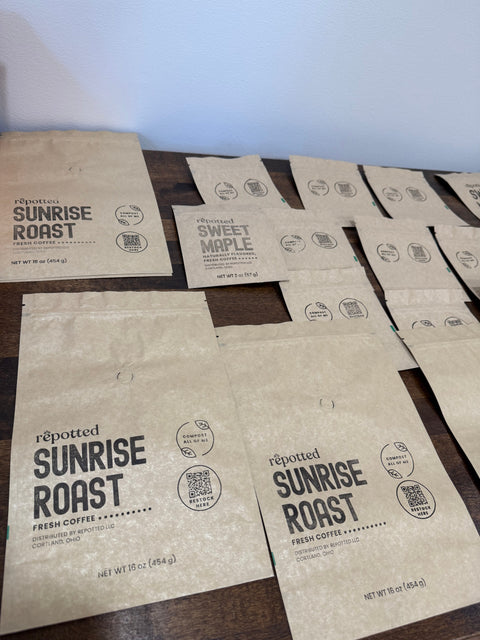repotted hand stamped compostable coffee bags on a table